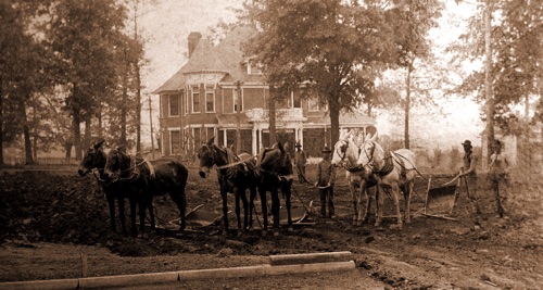 President Palmer's impressive home on the Alabama College campus. Workers preparing the site for the east wing expansion of Main Dorm. Palmer's house burned in 1921and was replaced by the house at Flower Hill in 1926.